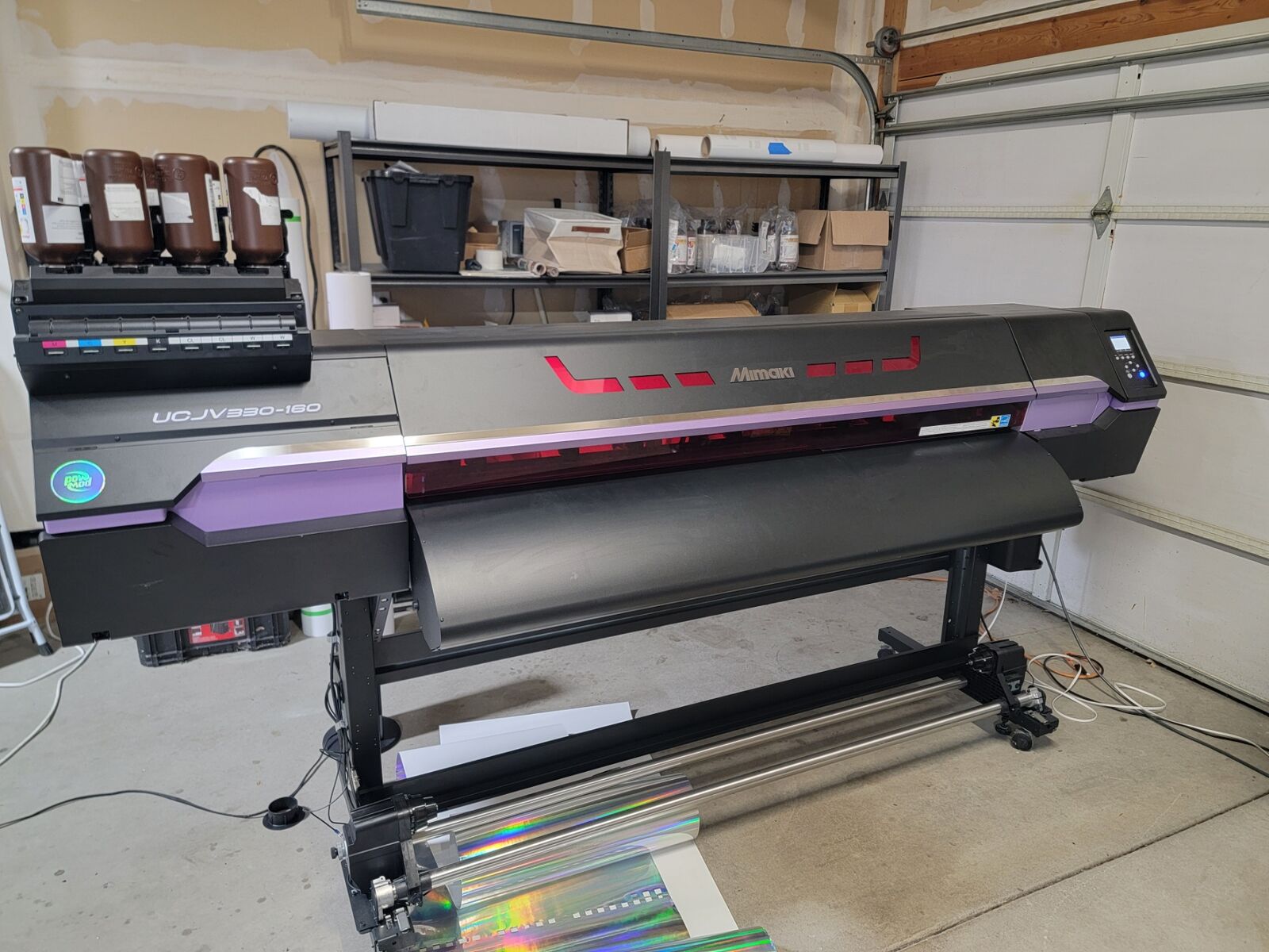Mimaki UCJV-330-160 UV roll-to-roll printer with print-and-cut capability.