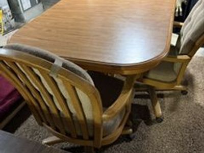 Dining Room Table and Three Padded Armed Rolling Chairs