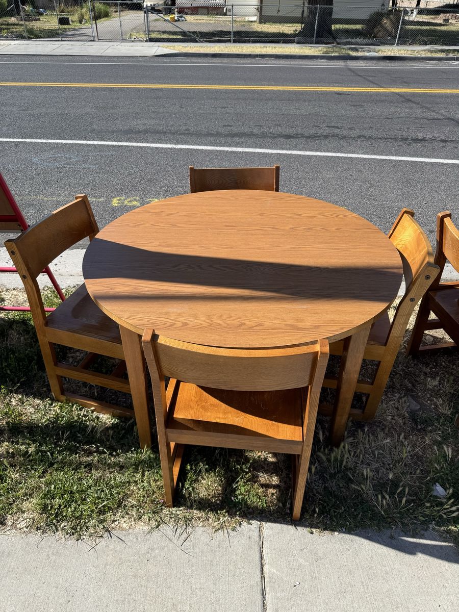 Round wooden table with four chairs