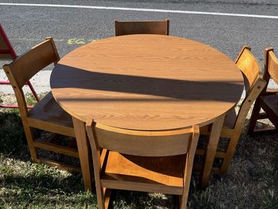 Round wooden table with four chairs