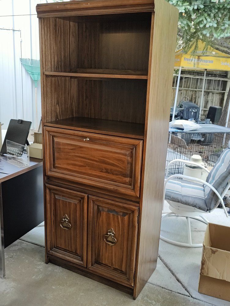 Wooden bookshelf with fold out writing surface. 30" wide x 73" tall x 16" deep.
