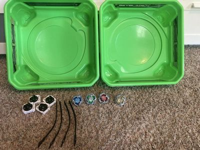 4 Beyblades, 2 arenas, & 3 Launchers - Used