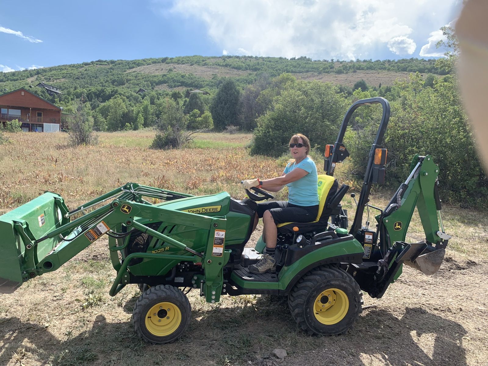 John Deere 1025R with implements