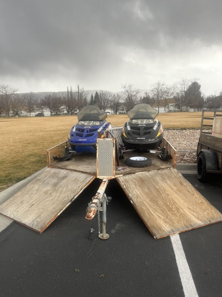 2 Polaris Snowmobiles And A Trailer