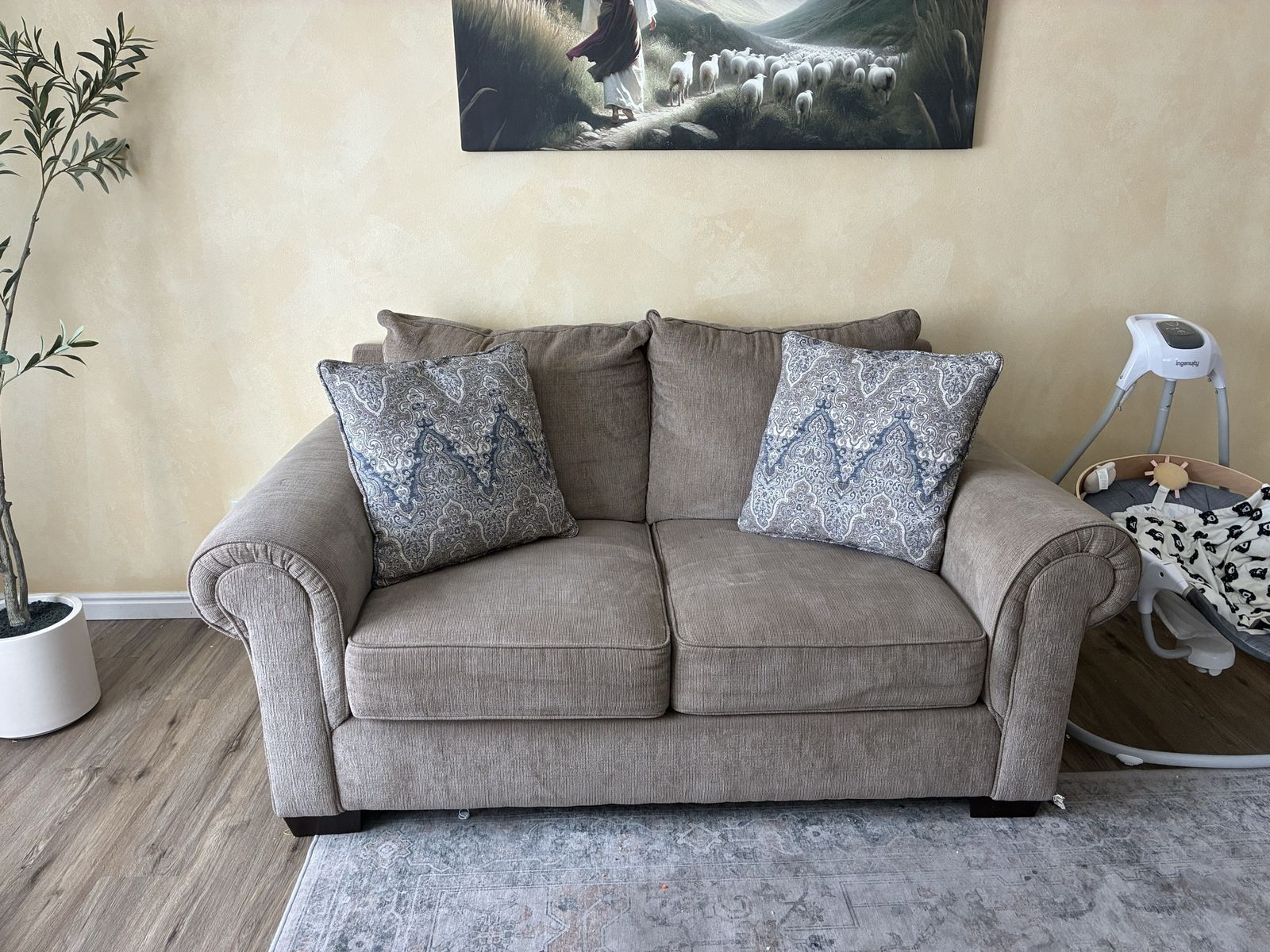 Taupe Fabric Loveseat with Rolled Arms.