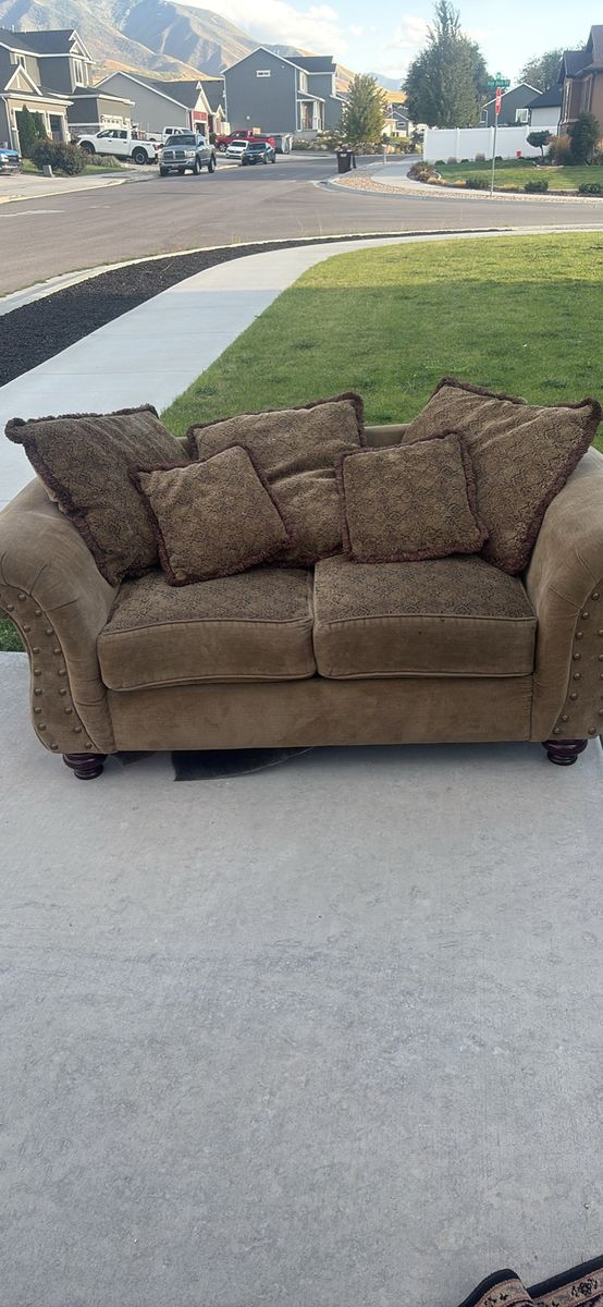 Brown Fabric Loveseat with Patterned Cushions and Nailhead Trim