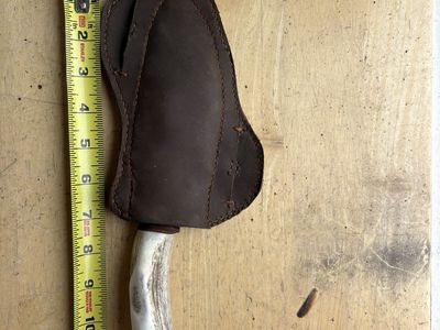 Handmade hunting knife with deer carved into to handle, stainless steel, leather sheath with kydex thermoform plastic inside