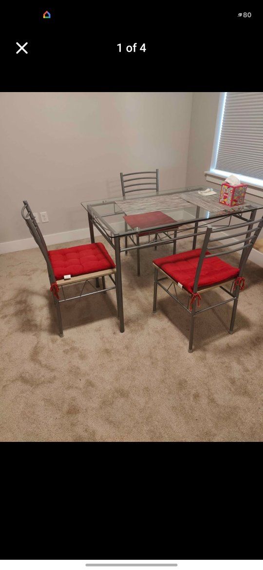 Dining Table & Chairs Set - Glass Top Table, 4 Metal Chairs w/ Red Cushions