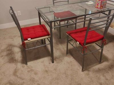 Dining Table & Chairs Set - Glass Top Table, 4 Metal Chairs w/ Red Cushions