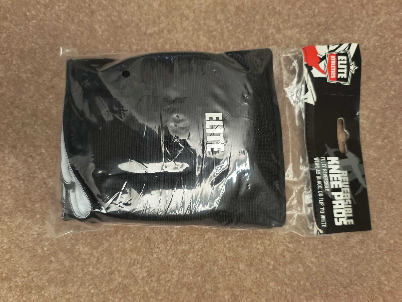 New in package reversible black or white knees pads