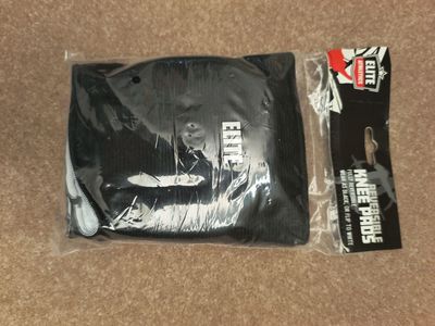 New in package reversible black or white knees pads