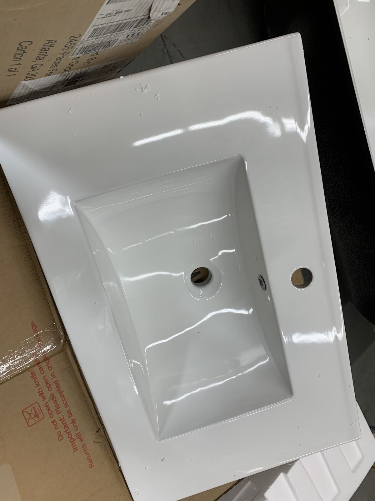 Single rectangular drop-in sink with overflow integrates with the countertop for a seamless appearance.