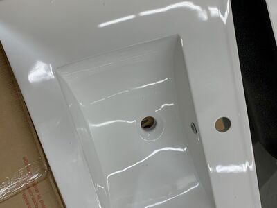 Single rectangular drop-in sink with overflow integrates with the countertop for a seamless appearance.