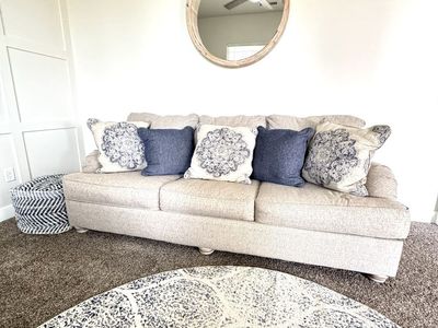 Ashley furniture sofa bed couch and over sized chair w/tags still attached. 2 new matching rugs and matching cube door rest.
