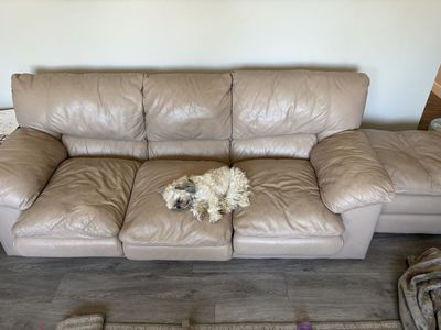 Tan Leather Couch with Plush Cushions and ottoman