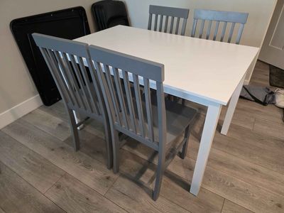 Modern White Dining Table with 4 Gray Chairs - Compact & Stylish