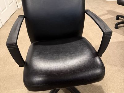 Four Black faux leather rolling desk chairs