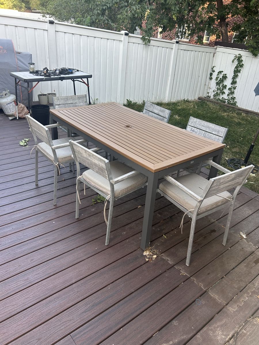 Teak topped outdoor dining table and chairs