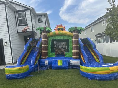 Duel water slide with bounce house