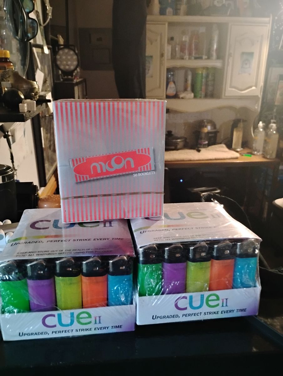 Two 50 count lighters and a box of 50 packs of 32 leafes