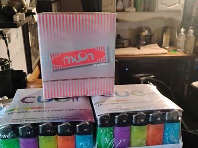 Two 50 count lighters and a box of 50 packs of 32 leafes