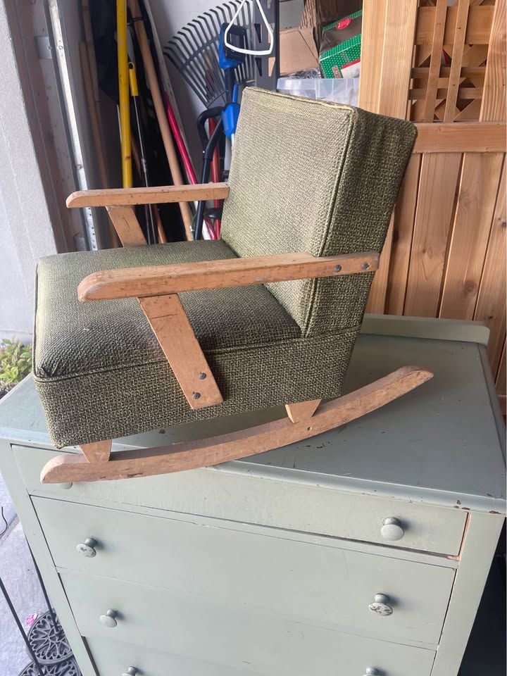 vintage Mid-Century Modern child's rocking chair features green textured vinyl upholstery and light