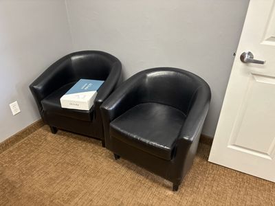 Pair of Black Faux Leather Barrel Accent Chairs