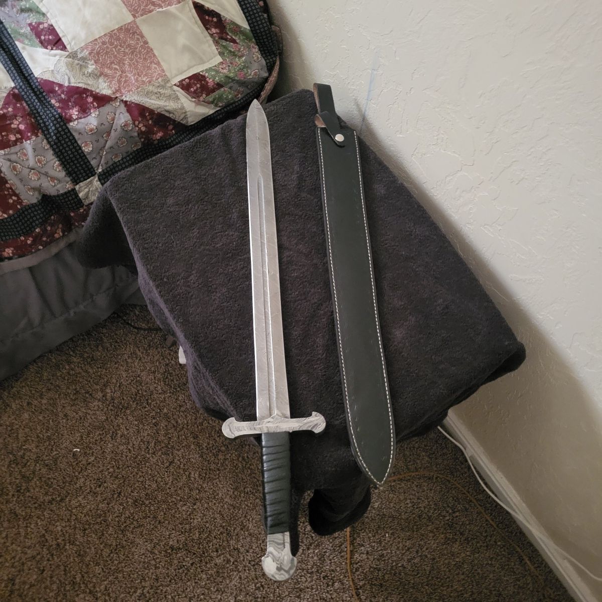 Hand forged Damascus sword with leather sheath.