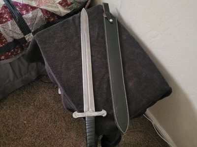Hand forged Damascus sword with leather sheath.