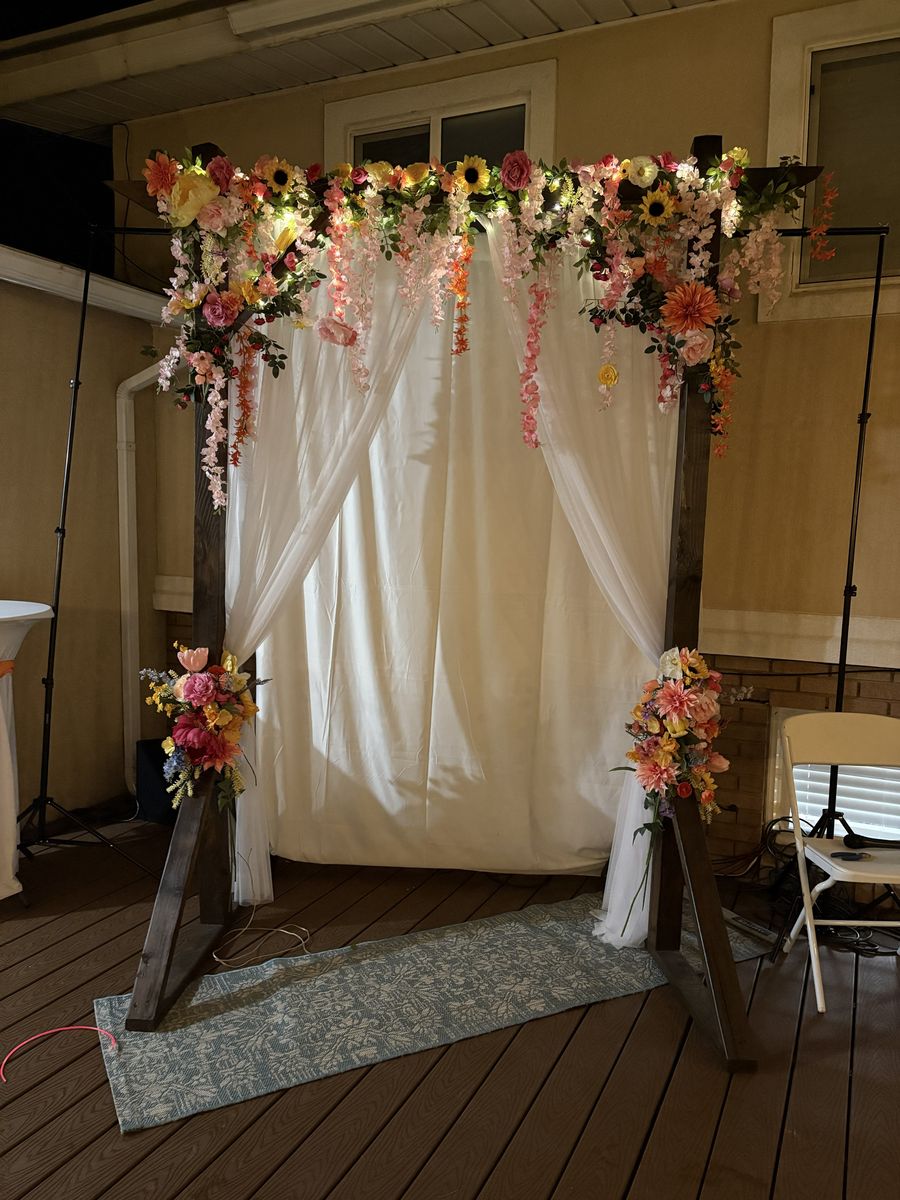 Wedding Arch with Flowers, lights, and drapery