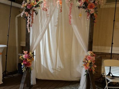 Wedding Arch with Flowers, lights, and drapery