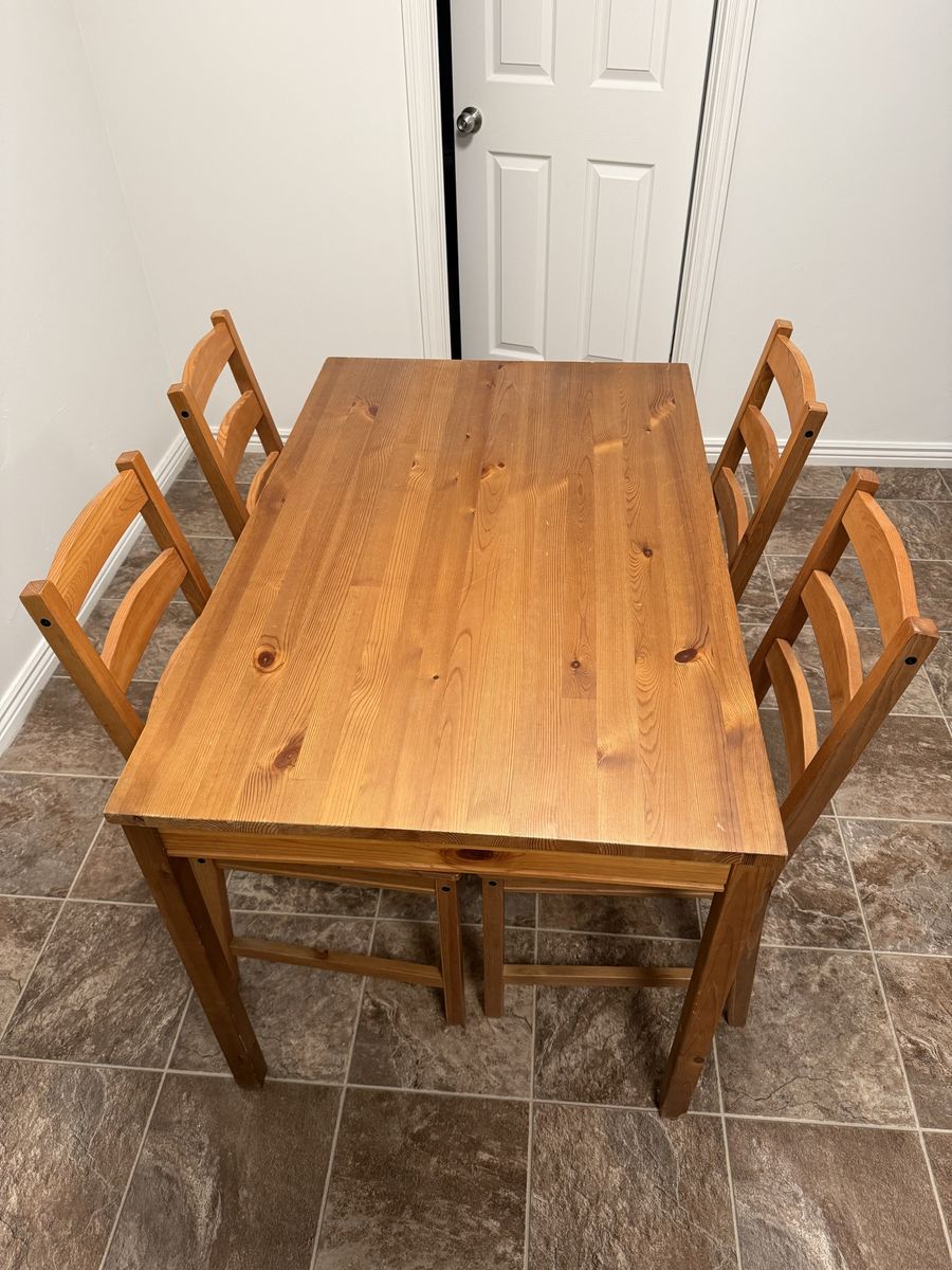 Dinner table set with chairs