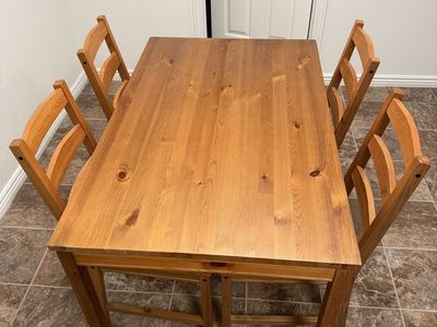 Dinner table set with chairs