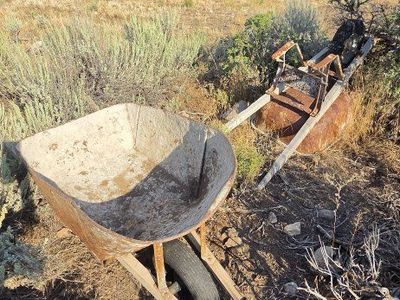 Vintage Metal Wheelbarrow Pair with Wooden Handles - Rust & Weathered Finish