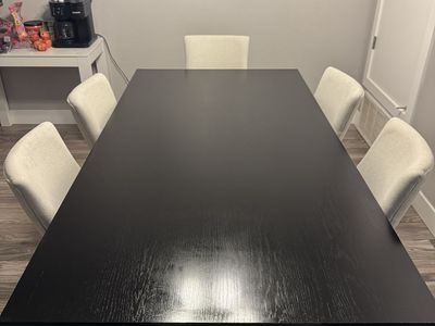 Black Dining Table with Cream Upholstered Chairs