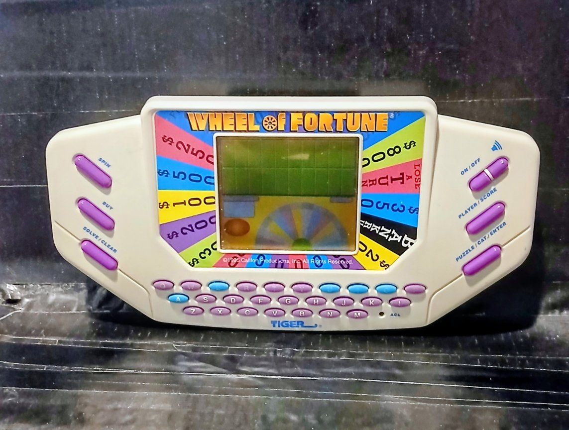 Tiger Wheel of Fortune Handheld Electronic Game 1995 Works Battery-Powered Puzzle Solver