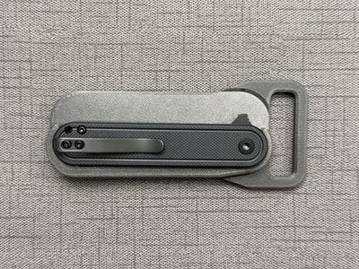 Knife with belt buckle holder