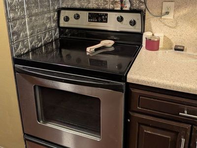Whirlpool Stainless Steel Electric Range with Smooth Glass Cooktop And Matching over the Stove Microwave Oven