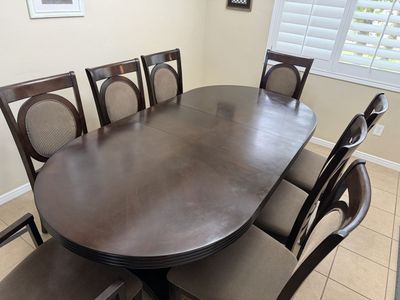 Dark Wood Oval Dining Table with 8 Upholstered Chairs - Extendable Leaf Included