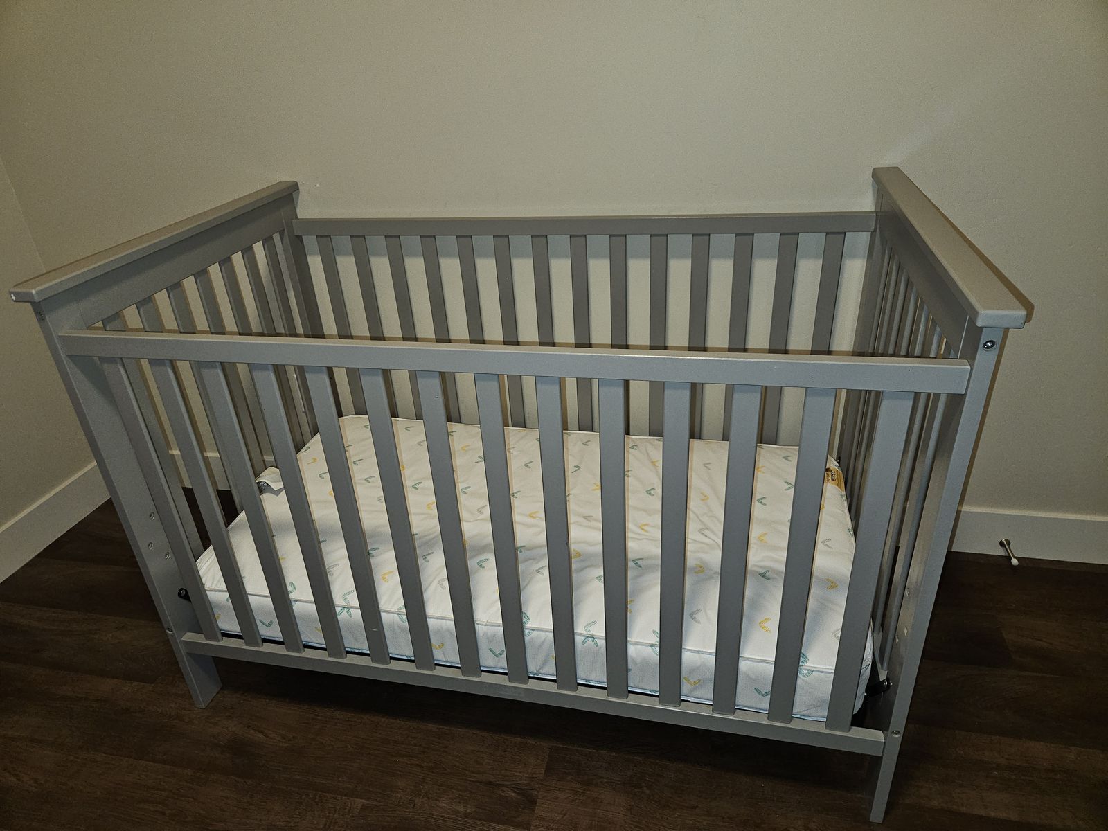 Grey crib and matress