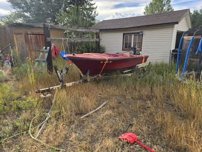 Red Jon Boat with Trailer, Outboard Motors, and Trolling Motor