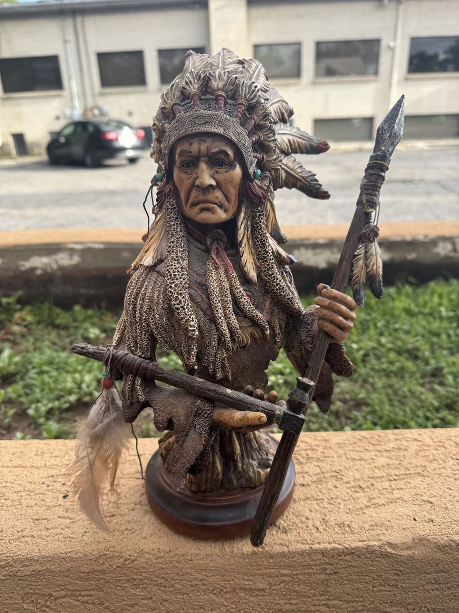 Sculpture of a Native American chief wearing a feathered headdress