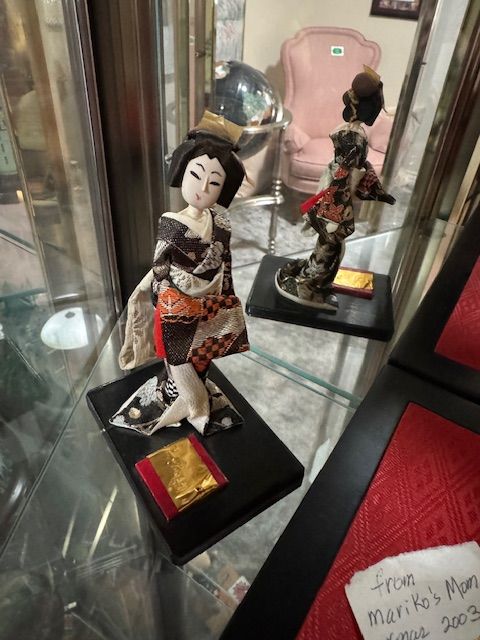 vintage Japanese geisha (or maiko-style) display doll dressed in a fabric kimono, mounted on a black base