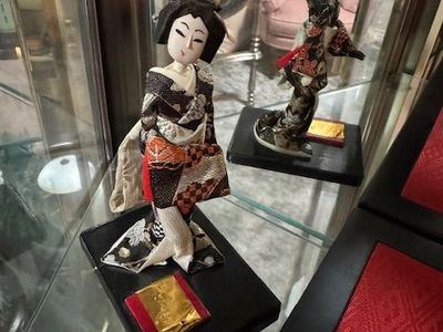 vintage Japanese geisha (or maiko-style) display doll dressed in a fabric kimono, mounted on a black base