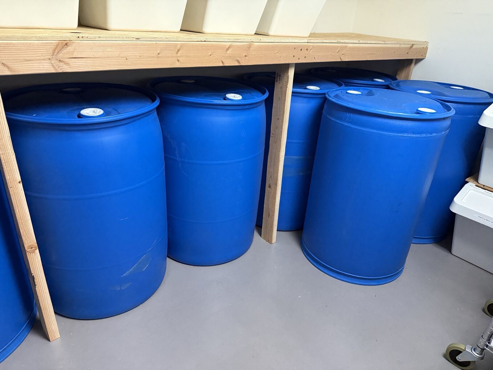 Ten 55 Gallon water storage barrels