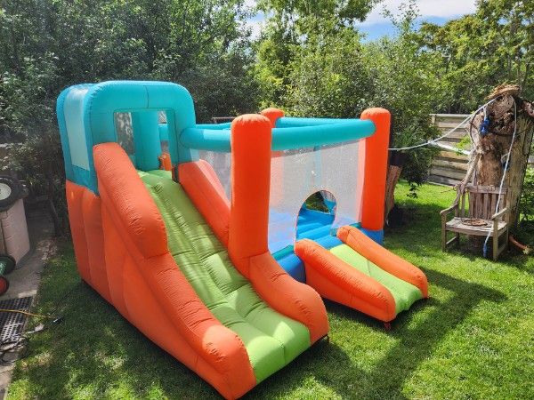 Colorful Inflatable Bounce House with Double Slides - Perfect for Kids' Parties and Outdoor Fun