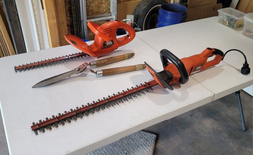 All for $40! 2 Black and Decker Electric Hedge Trimmers and 1 Hand Trimmer