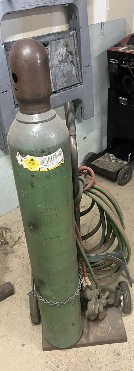 Oxygen tank with gauges and hoses.