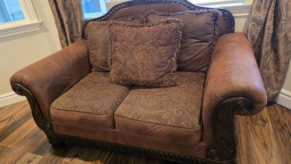 Traditional Brown Accent Loveseat with Ornate Carved Wood Trim and Paisley Cushions