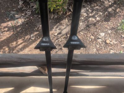 Thule roof rack crossbars for a camper shell.